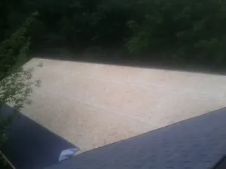 New OSB roof sheathing installed beside an existing shingle roof in Moscow